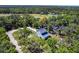 A beautiful aerial view of the home is surrounded by mature trees and close neighbors at 14289 Manatee Rd, Parrish, FL 34219