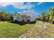 Two-story home featuring a covered patio and a spacious backyard on a lush green lawn at 14289 Manatee Rd, Parrish, FL 34219