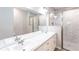 Bright bathroom featuring double sinks, a large mirror, white cabinetry and a walk-in shower, perfect for modern living at 14289 Manatee Rd, Parrish, FL 34219