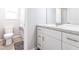 Bathroom featuring a white vanity with modern hardware, toilet, and window at 14289 Manatee Rd, Parrish, FL 34219