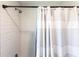 Modern bathroom featuring subway tile, sleek showerhead, and a patterned shower curtain at 14289 Manatee Rd, Parrish, FL 34219