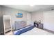 Bedroom features wood-look floors, a television, and a white bedframe at 14289 Manatee Rd, Parrish, FL 34219