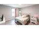 Bright bedroom with a full bed, white metal frame, large window, and a comfortable space for relaxation and rest at 14289 Manatee Rd, Parrish, FL 34219