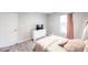 Cozy bedroom features a white dresser, window, light grey walls and wood grain floors at 14289 Manatee Rd, Parrish, FL 34219