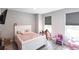 Bedroom features wood-look floors, a window, and a white bedframe at 14289 Manatee Rd, Parrish, FL 34219