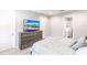Relaxing bedroom featuring a comfortable queen-sized bed, dresser with a TV, and an adjacent bathroom at 14289 Manatee Rd, Parrish, FL 34219