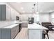 Spacious kitchen with modern appliances, featuring an island with seating and gray cabinetry at 14289 Manatee Rd, Parrish, FL 34219