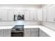 Modern kitchen with gray cabinets, stainless steel appliances, and a smooth cooktop at 14289 Manatee Rd, Parrish, FL 34219