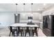 Sleek kitchen featuring a large island with seating, gray cabinets, and stainless steel appliances at 14289 Manatee Rd, Parrish, FL 34219