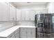 Well-appointed kitchen featuring sleek stainless steel appliances, gray cabinets, and ample counter space at 14289 Manatee Rd, Parrish, FL 34219