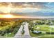 Beautiful aerial vista showcasing the community entrance and vibrant sunset at 14381 Heritage Landing Blvd, Punta Gorda, FL 33955