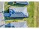 Aerial view of a home with a tile roof, lush landscaping, and a paved driveway at 14381 Heritage Landing Blvd, Punta Gorda, FL 33955