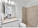 Well-lit bathroom featuring a granite countertop, tiled shower, and a view of the bedroom at 14381 Heritage Landing Blvd, Punta Gorda, FL 33955