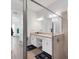 Bright bathroom featuring a granite vanity, glass shower, and neutral colors at 14381 Heritage Landing Blvd, Punta Gorda, FL 33955