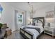 Bedroom with hardwood floors, chandelier lighting, a decorative bed, and soft colors at 14381 Heritage Landing Blvd, Punta Gorda, FL 33955
