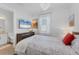 Comfortable bedroom with mounted TV and an en-suite bathroom providing ultimate privacy and convenience at 14381 Heritage Landing Blvd, Punta Gorda, FL 33955