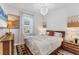 Inviting bedroom showcasing neutral decor, a large window with curtains, and stylish furnishings at 14381 Heritage Landing Blvd, Punta Gorda, FL 33955