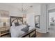 Bedroom with hardwood floors, chandelier lighting, an accent mirror and neutral colors at 14381 Heritage Landing Blvd, Punta Gorda, FL 33955