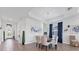Elegant dining room with a modern chandelier, tray ceiling, stylish decor, and ample natural light at 14381 Heritage Landing Blvd, Punta Gorda, FL 33955