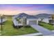 Charming single-Gathering home with an attached garage, a stone driveway, and a well-maintained lawn at 14381 Heritage Landing Blvd, Punta Gorda, FL 33955