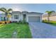 Traditional home with a paved driveway, beautiful landscaping and inviting curb appeal at 14381 Heritage Landing Blvd, Punta Gorda, FL 33955
