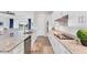 Bright kitchen featuring white cabinetry, granite countertops, a large island, and stainless steel appliances at 14381 Heritage Landing Blvd, Punta Gorda, FL 33955