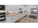 Well-lit kitchen with white cabinets, granite countertops, stainless appliances, and modern fixtures and hardware at 14381 Heritage Landing Blvd, Punta Gorda, FL 33955