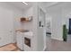 Practical laundry room equipped with modern appliances and storage solutions for efficient chores at 14381 Heritage Landing Blvd, Punta Gorda, FL 33955