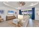 Bright living room with wood floors, a modern fan, sliding glass doors and a comfortable couch at 14381 Heritage Landing Blvd, Punta Gorda, FL 33955