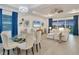 Open floor plan living room featuring wood floors, modern decor, dining table and comfortable couch at 14381 Heritage Landing Blvd, Punta Gorda, FL 33955