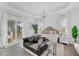 Bright main bedroom with chandelier lighting, tray ceilings, and access to an outdoor lanai at 14381 Heritage Landing Blvd, Punta Gorda, FL 33955
