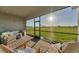 Relaxing screened-in patio offering comfortable seating and a view of the lush green landscape at 14381 Heritage Landing Blvd, Punta Gorda, FL 33955