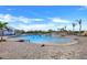 Gorgeous community pool with shallow beach entry, sun loungers, and palm trees for a resort-style living experience at 14381 Heritage Landing Blvd, Punta Gorda, FL 33955