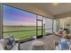 Covered porch with brick flooring, and comfortable seating with a scenic sunset view at 14381 Heritage Landing Blvd, Punta Gorda, FL 33955