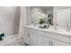 Bathroom featuring double sinks with white cabinetry, framed mirrors, recessed lighting and tiled walk-in shower at 16290 Maya Cir, Punta Gorda, FL 33955