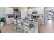 Bright kitchen featuring a large island with seating, stainless steel appliances, and pendant lighting at 16290 Maya Cir, Punta Gorda, FL 33955