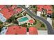 An aerial view showcases a community pool with neat landscaping, nestled among homes with distinctive red roofs at 1780 Deborah Dr # 25, Punta Gorda, FL 33950