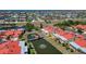 Wide aerial perspective of a community, highlighting homes, a pond with gazebo, and lush landscape at 1780 Deborah Dr # 25, Punta Gorda, FL 33950