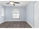 A bright bedroom with hardwood floors, two windows, ceiling fan and a built in closet at 1780 Deborah Dr # 25, Punta Gorda, FL 33950
