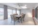 Sunroom dining area with tile floors, skylight, updated ceiling fan, and lots of natural light at 1780 Deborah Dr # 25, Punta Gorda, FL 33950