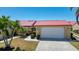 Charming single-story home featuring a red roof, well-manicured lawn, and attached garage, perfect for comfortable living at 1780 Deborah Dr # 25, Punta Gorda, FL 33950