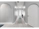 Hallway with arched doorways, light gray walls, and wood floors, leading to various rooms in the home at 1780 Deborah Dr # 25, Punta Gorda, FL 33950