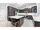 Stylish kitchen with dark cabinets, quartz countertops, and modern appliances, perfect for culinary enthusiasts at 1780 Deborah Dr # 25, Punta Gorda, FL 33950