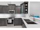 Close-up of a well-equipped kitchen featuring stainless steel appliances, subway tile backsplash, and ample counter space at 1780 Deborah Dr # 25, Punta Gorda, FL 33950