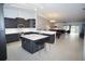 A modern, open concept kitchen featuring stainless steel appliances, white countertops, and an island with seating at 1780 Deborah Dr # 25, Punta Gorda, FL 33950