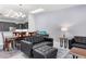 An elegant living room with leather seating, a wooden dining table, and a view into the modern kitchen at 1780 Deborah Dr # 25, Punta Gorda, FL 33950