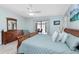 Bedroom with a ceiling fan, a serene color scheme, and sliding glass doors leading to the backyard at 1780 Deborah Dr # 25, Punta Gorda, FL 33950