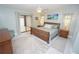 A serene main bedroom with a ceiling fan, sliding glass doors, and views of tropical artwork at 1780 Deborah Dr # 25, Punta Gorda, FL 33950
