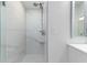 Modern bathroom shower featuring marble-look tile walls, hexagonal tile floor, and convenient built-in shelves at 1780 Deborah Dr # 25, Punta Gorda, FL 33950
