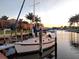 Waterfront view with a sailboat docked, palm trees, and residences in the background at 1780 Deborah Dr # 25, Punta Gorda, FL 33950